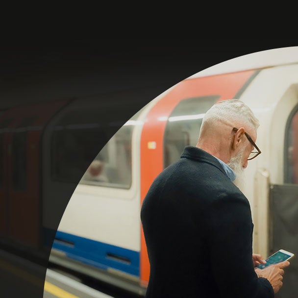 A man on subway platform as train arrives.