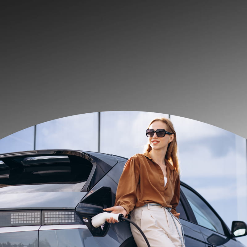 woman next to an electric vehicle