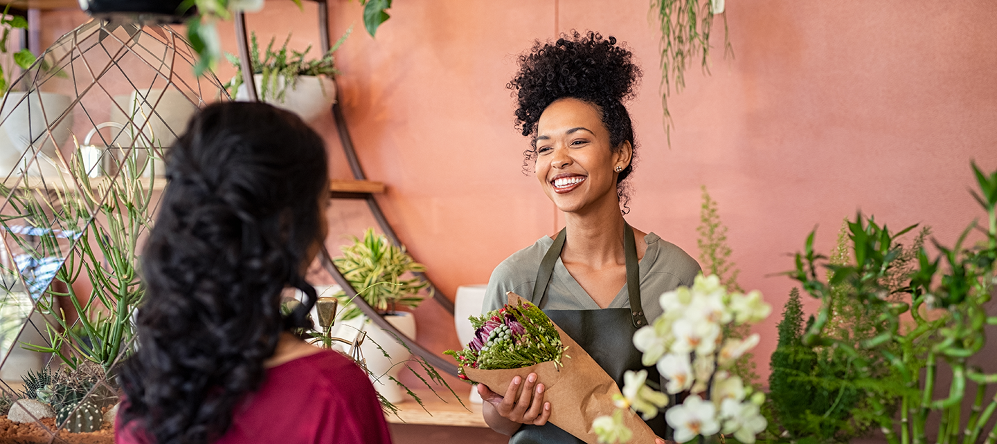 Woman selling personalized flowers to a customer