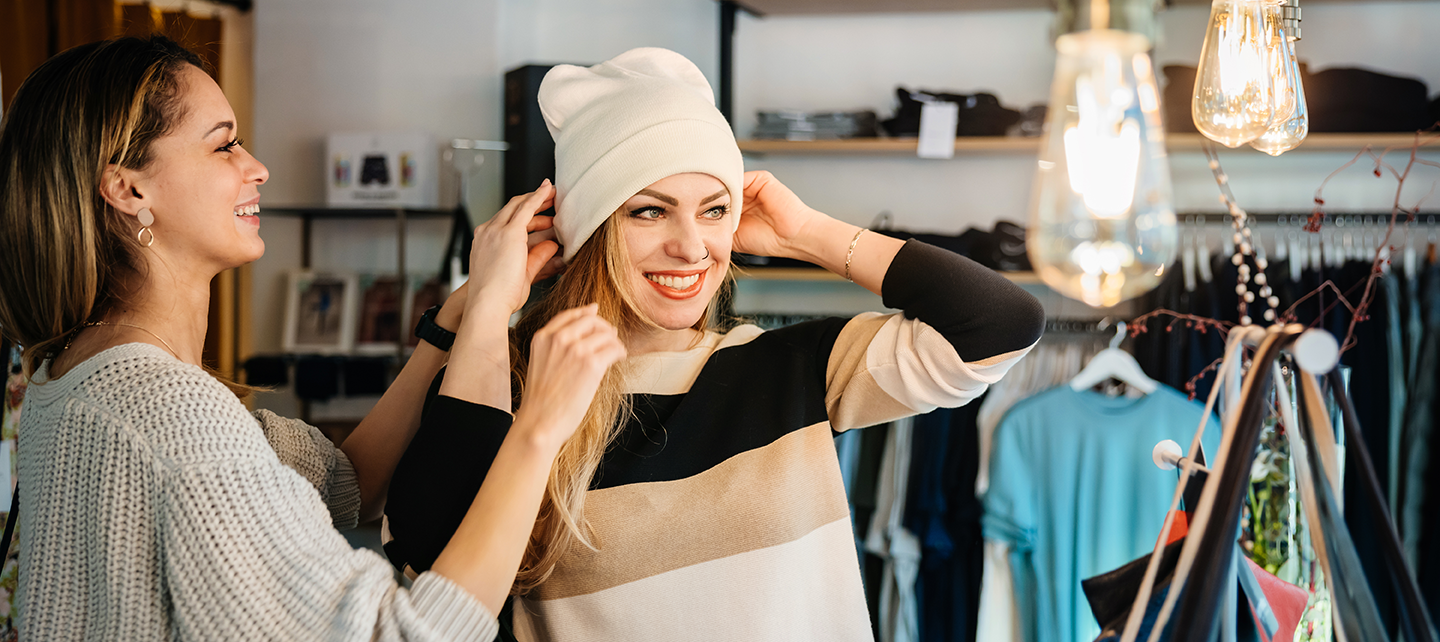 Woman shopping for hats at a clothing store