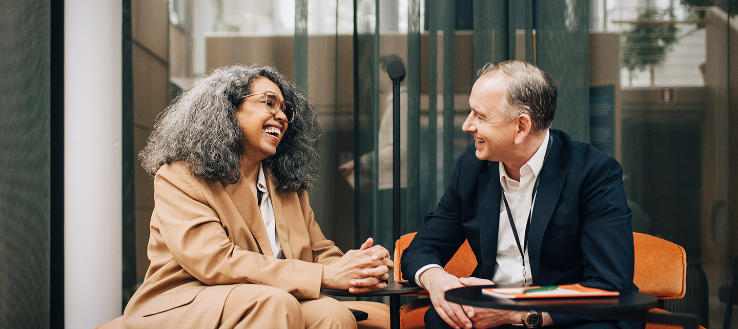 Man and woman coworkers laughing together