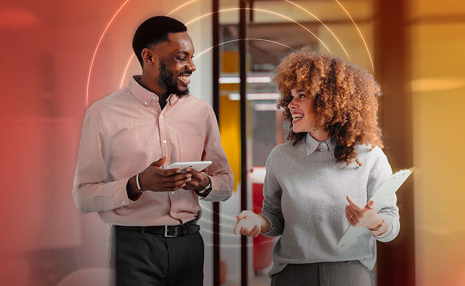 woman & man discussing smiling each other holding tablet in hand
