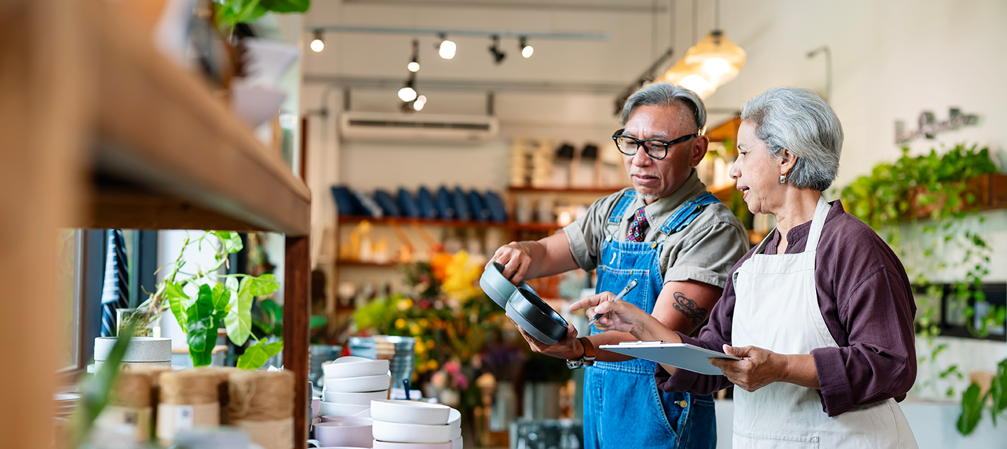 Older employee helping older woman make a decision