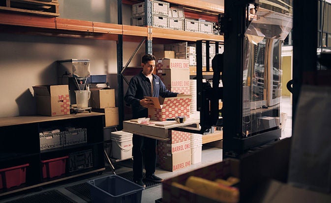 worker in warehouse packing boxes