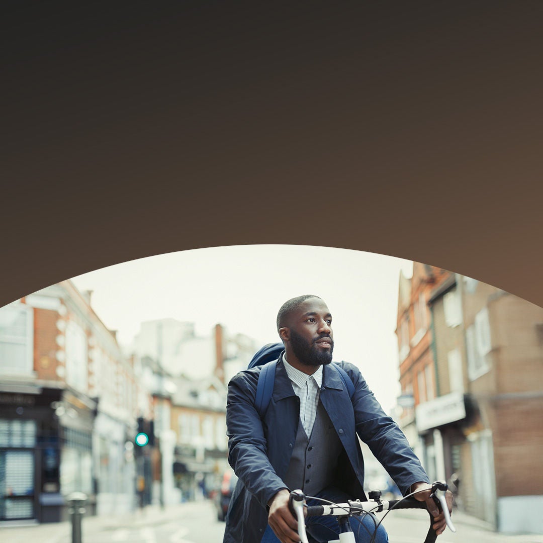 Man riding bicycle in city street.