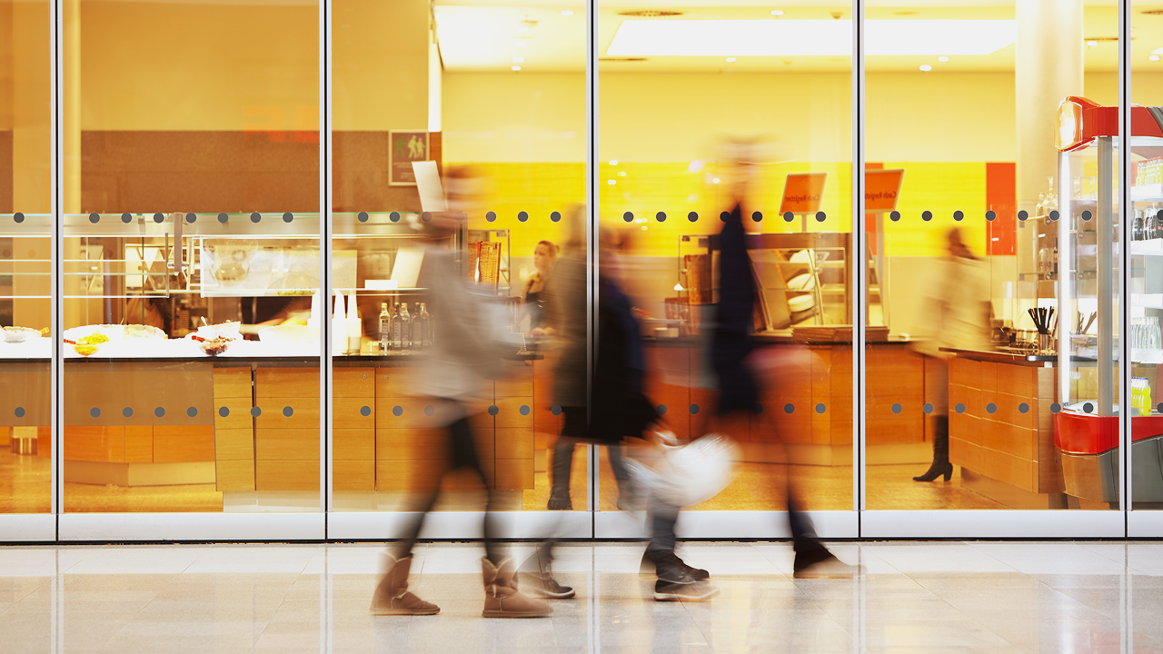 A blured image of people walking in a public space