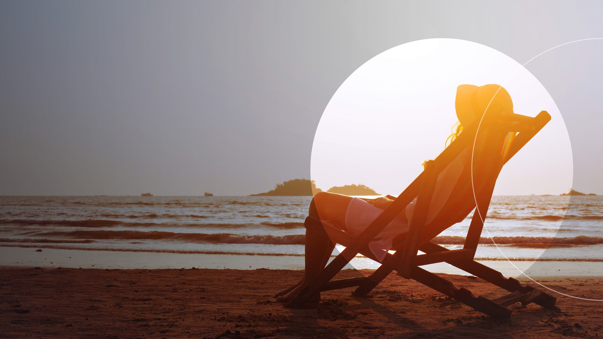 A beach scene featuring a woman seated in a chair, enjoying the sun and ocean view.