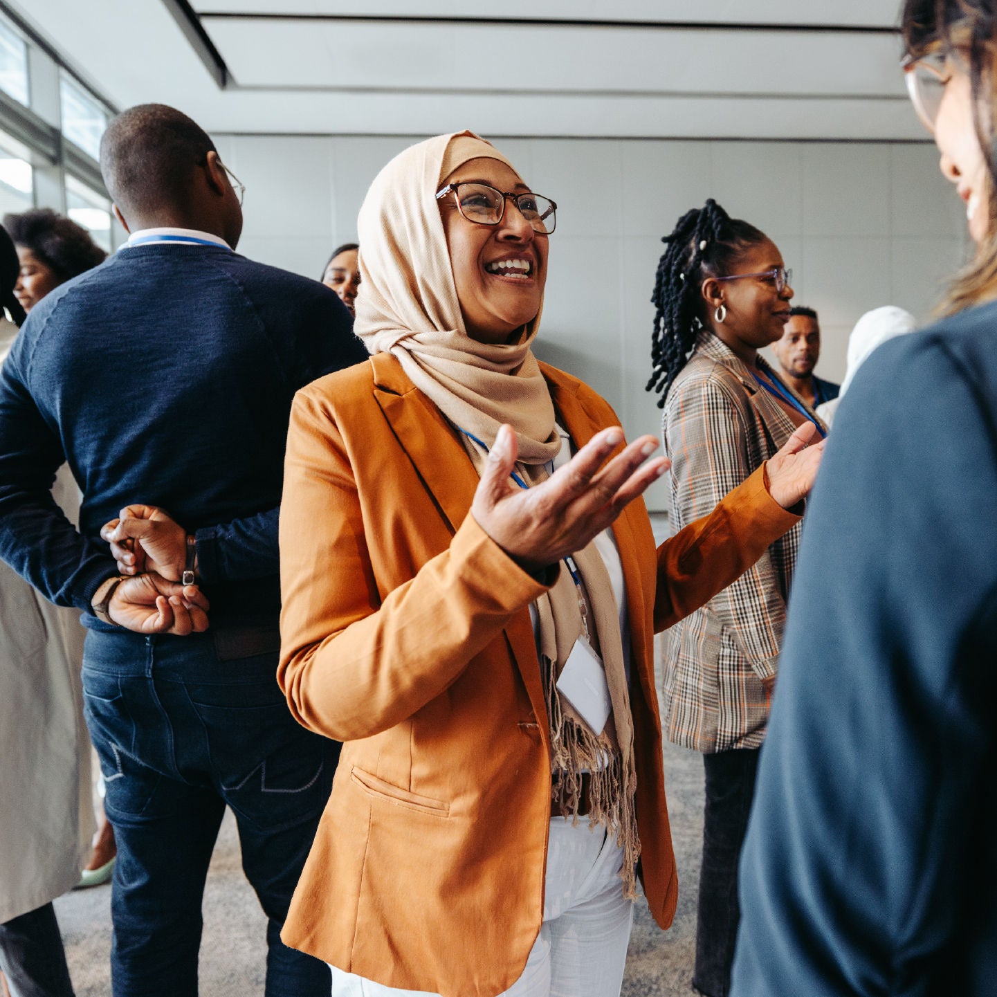 Woman talking with her hands in a group of people