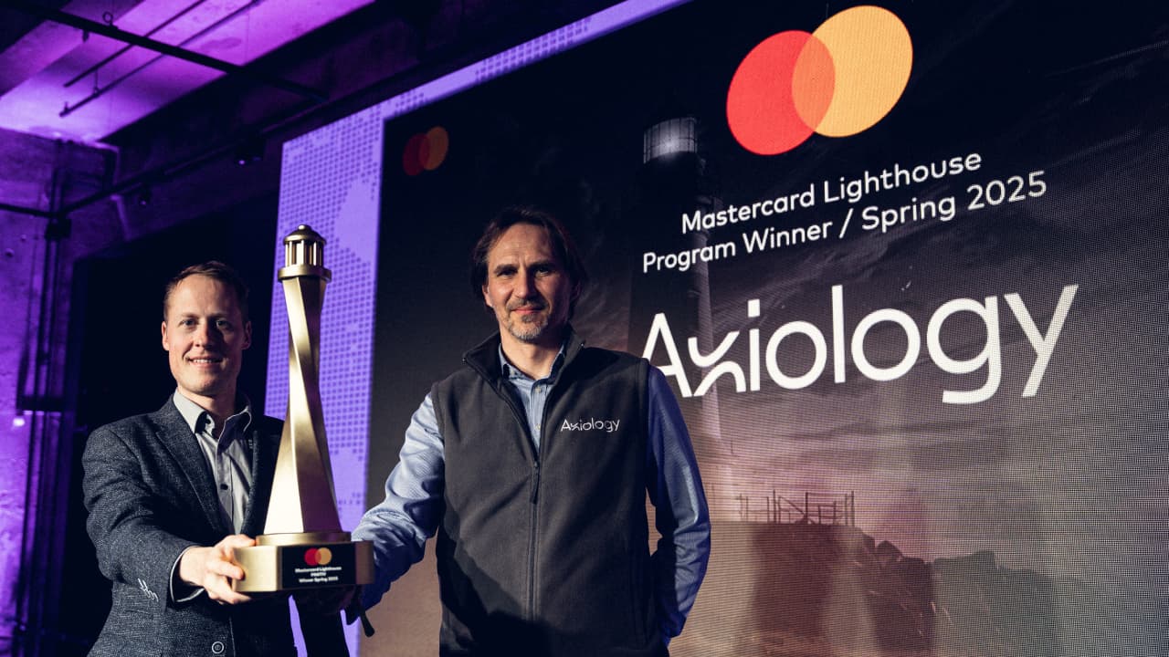axiology spring winner trophy handshake 2025
