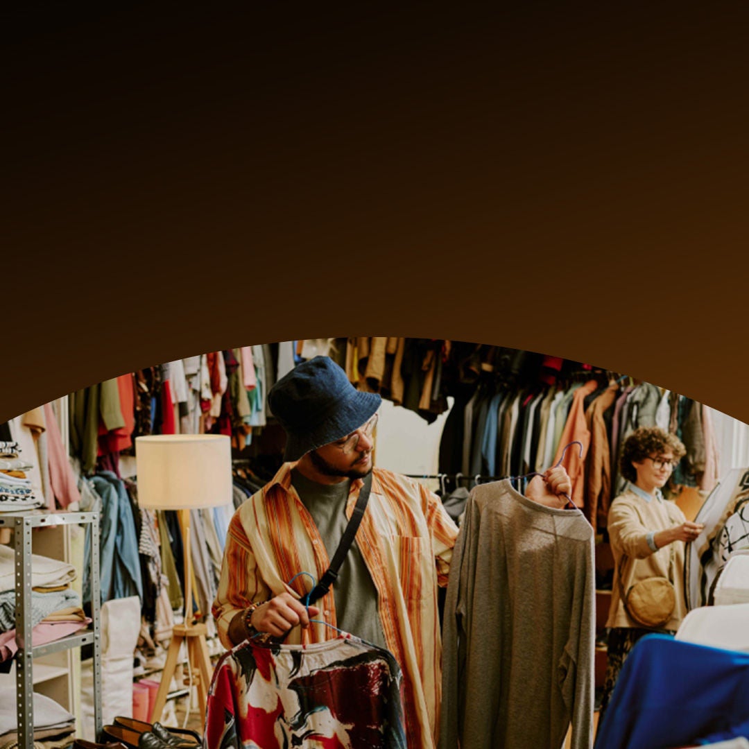 Man shopping for clothes in a marketplace