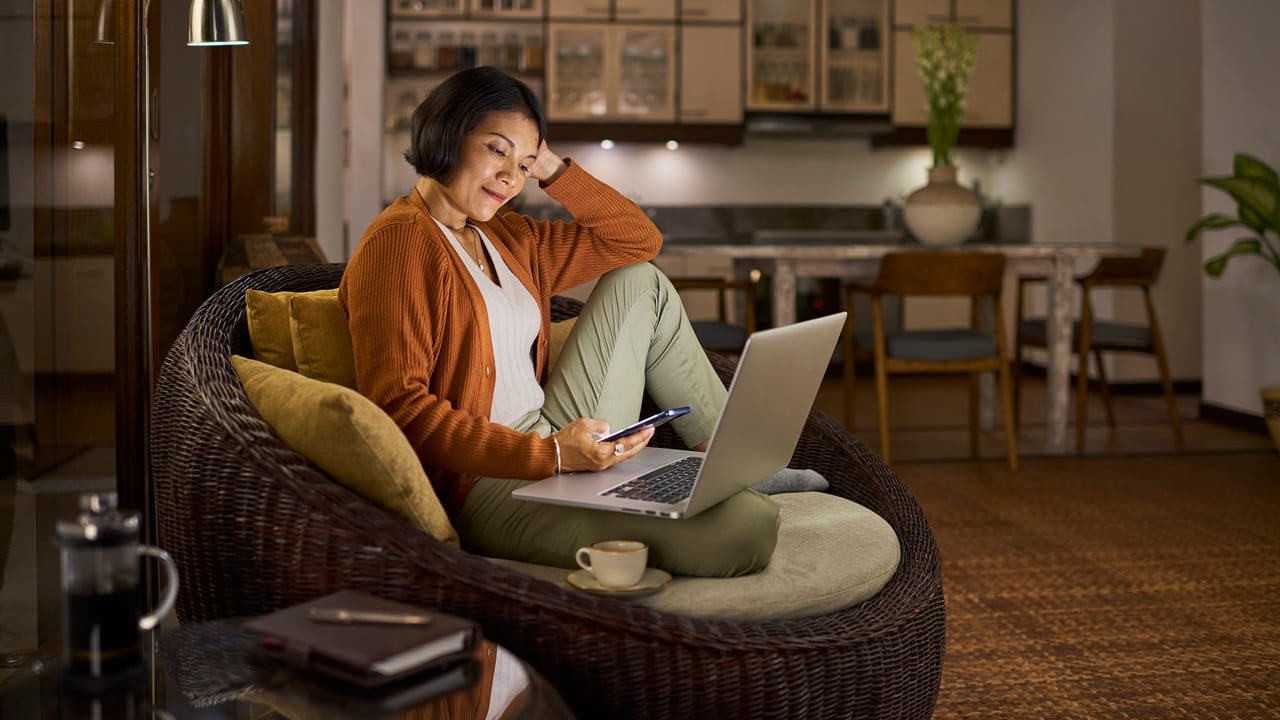 woman relaxing at home with a laptop phone