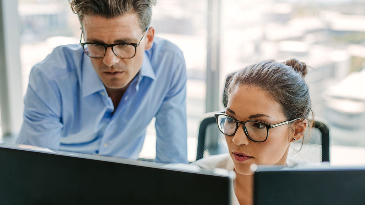 Focused business team using a computer in office.