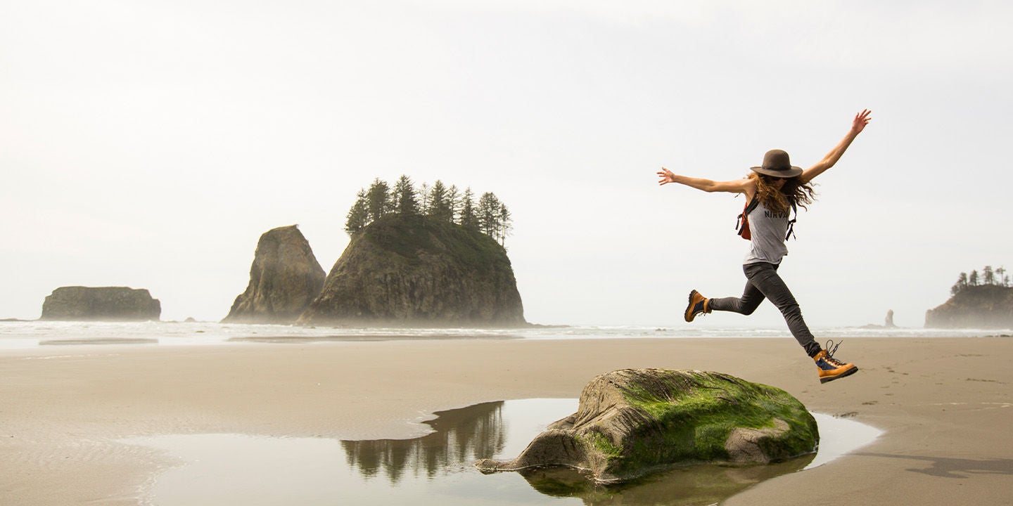 Woman jumping by the beach