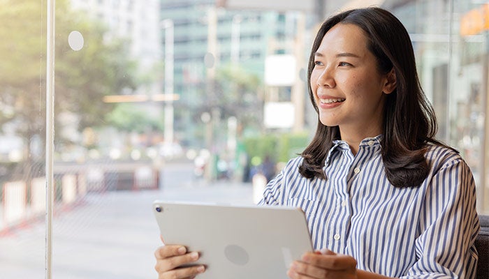 Woman on tablet outside
