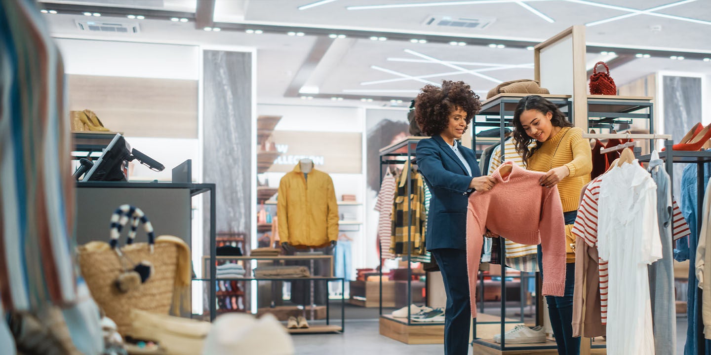 Two women shopping clothes at a store