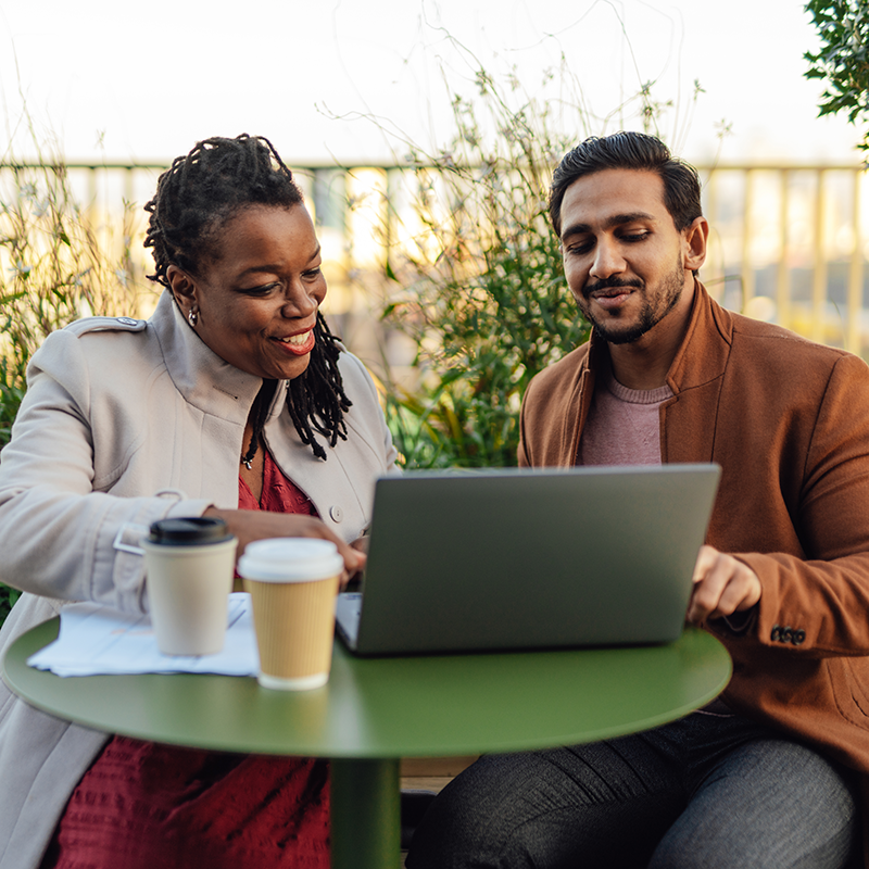 Man and woman discussing business while getting coffee