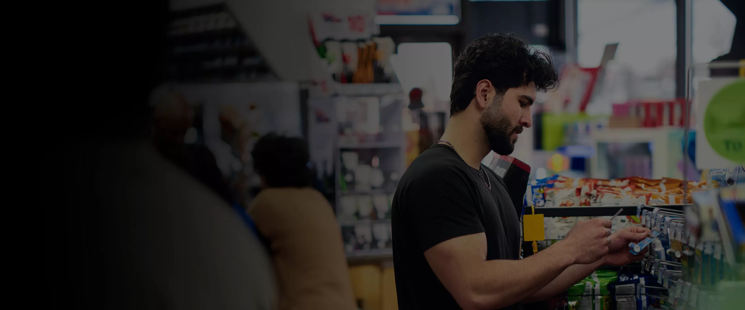 Man looking at products in a convenience store