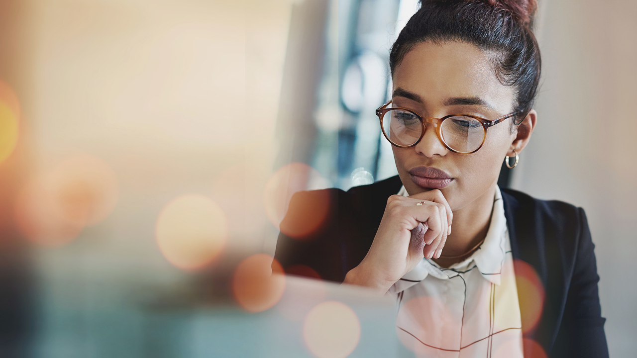 Woman thinking whilst working