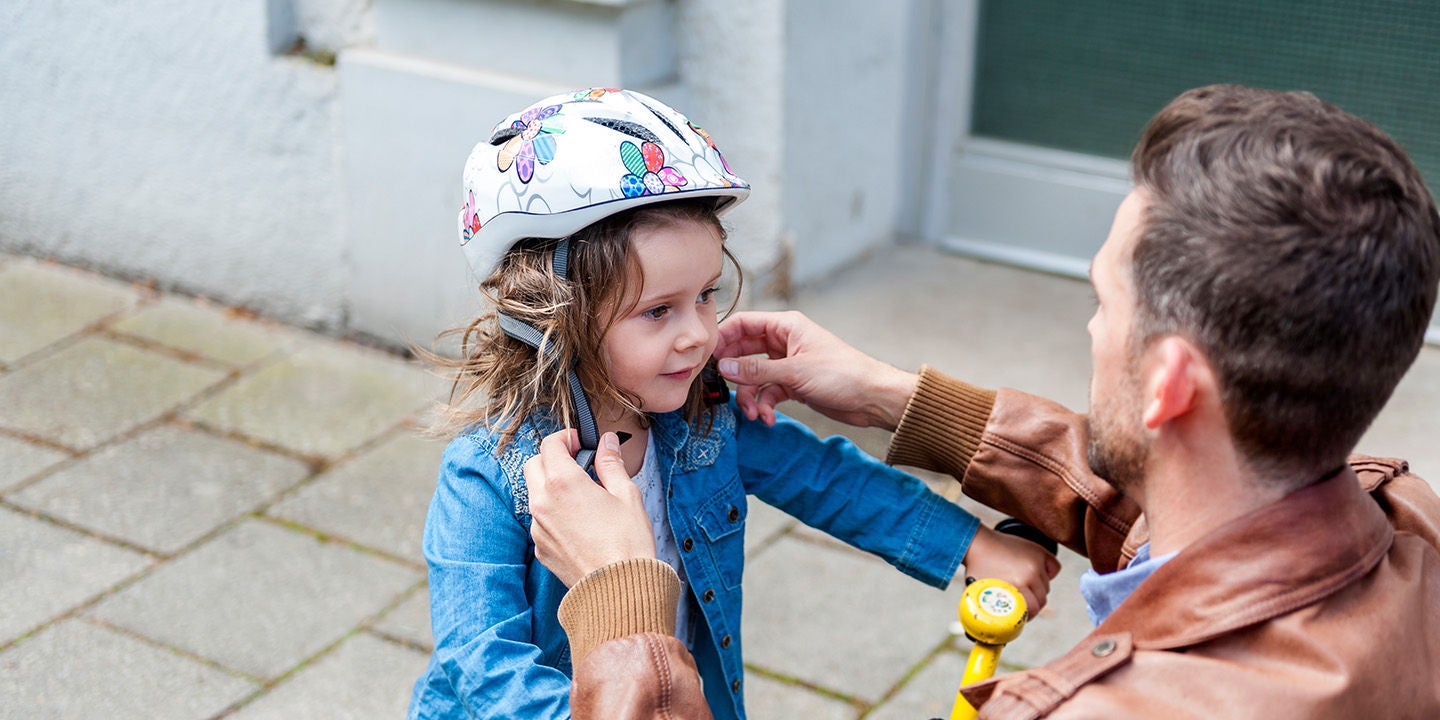 Father and daughter playing with bicycle
