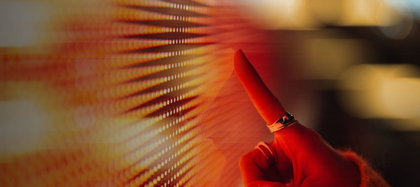 A person pointing at a screen with a finger
