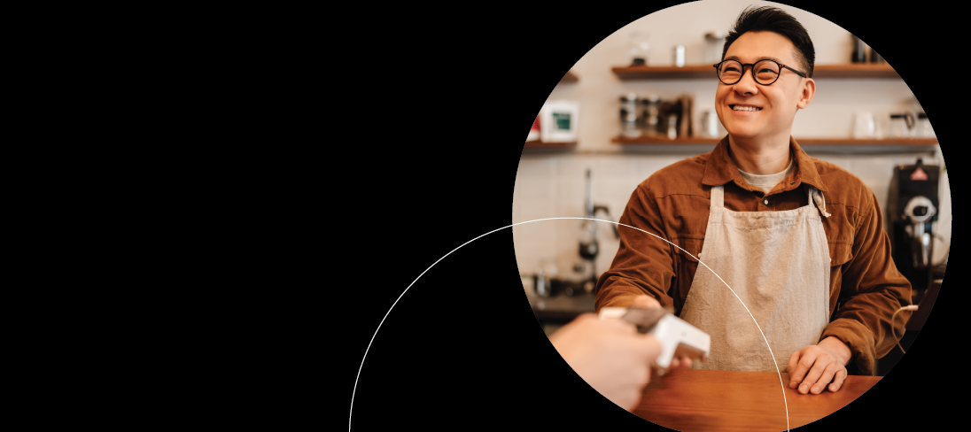 Man working at coffee shop taking payment