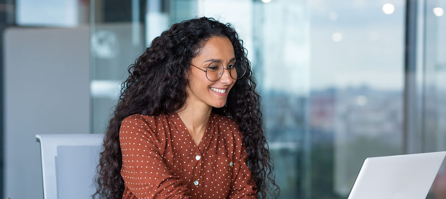 Woman smiling as she does her work in the office
