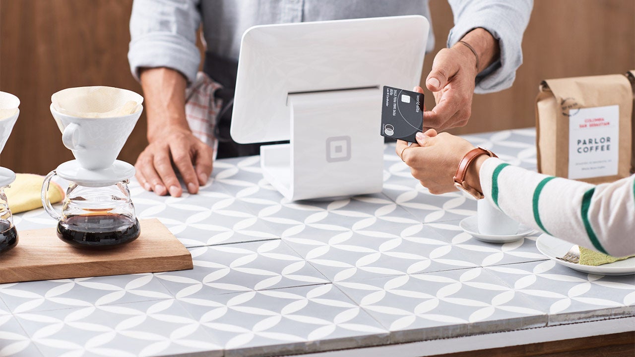 Crowd outside a building bearing the Mastercard logo.