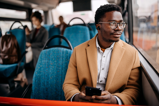 Man on public transport looking out window
