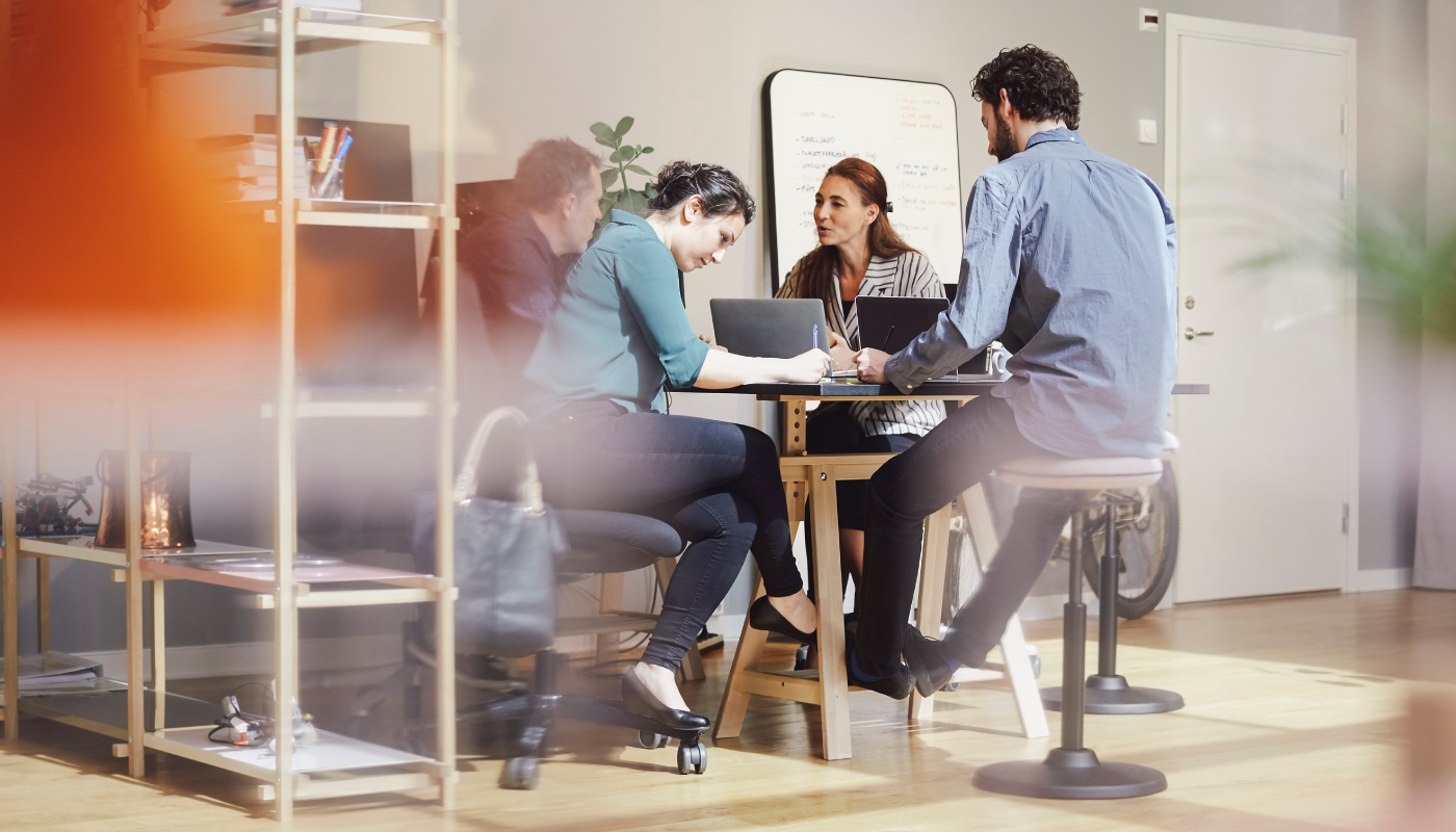 Three people conversing in the break room