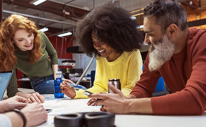 Team collaborating around a table in an office.