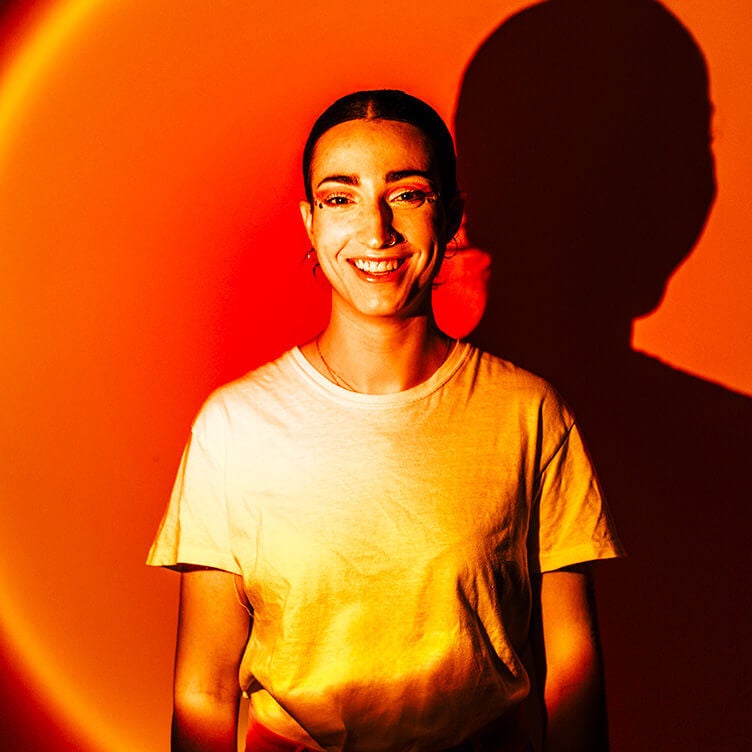 Woman smiling on an orange background