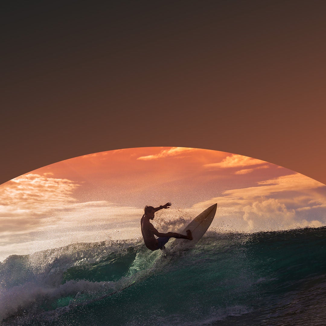 Man surfs at dawn.