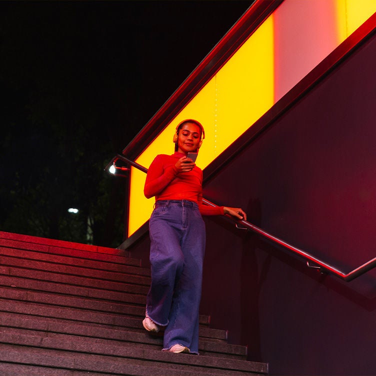 Woman going down the stairs at night