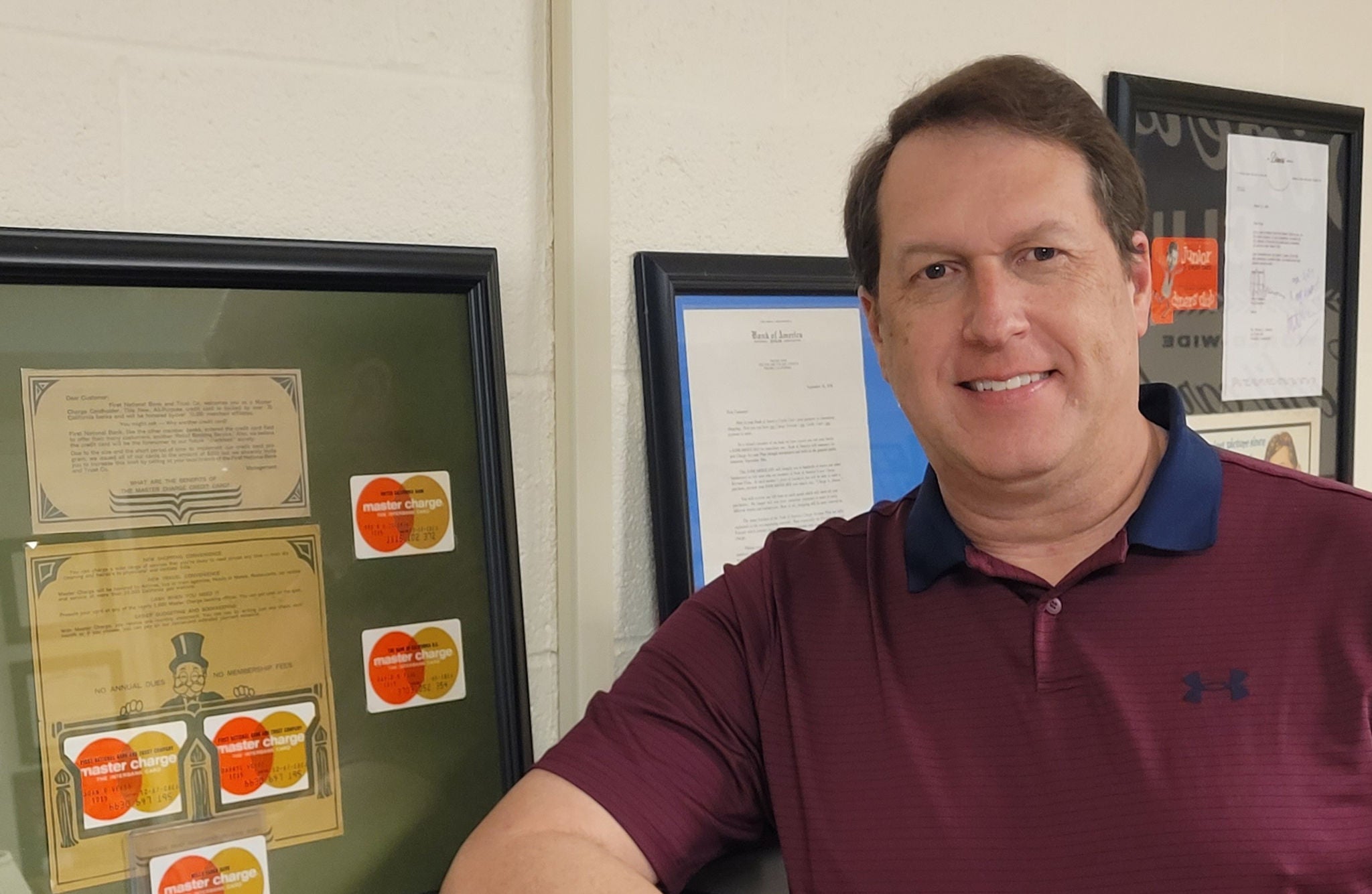 Scott Nimmo in front of his collection of Master Charges.