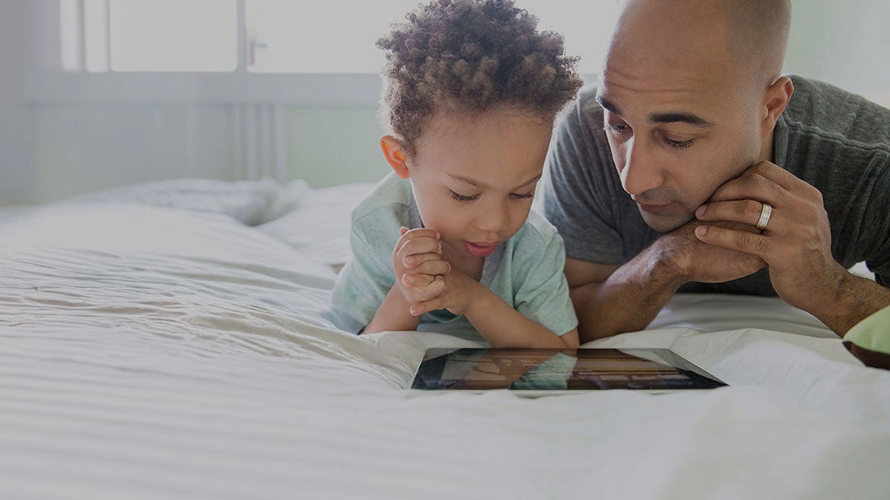 Father and son checking a tablet