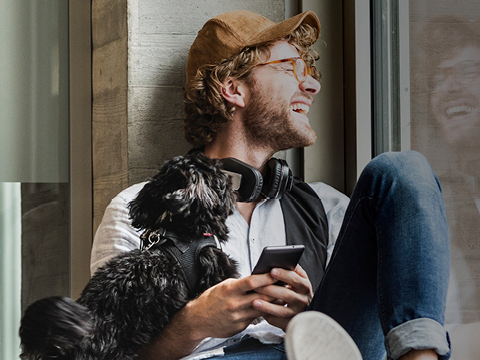 Man smiling looking out window