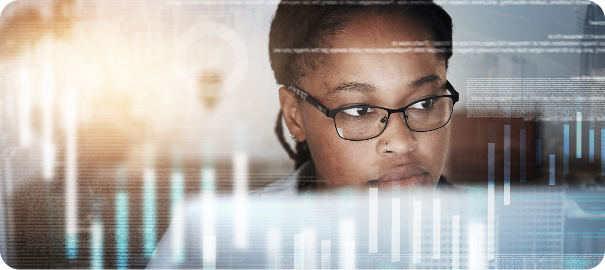 A woman with glasses looking at a computer screen