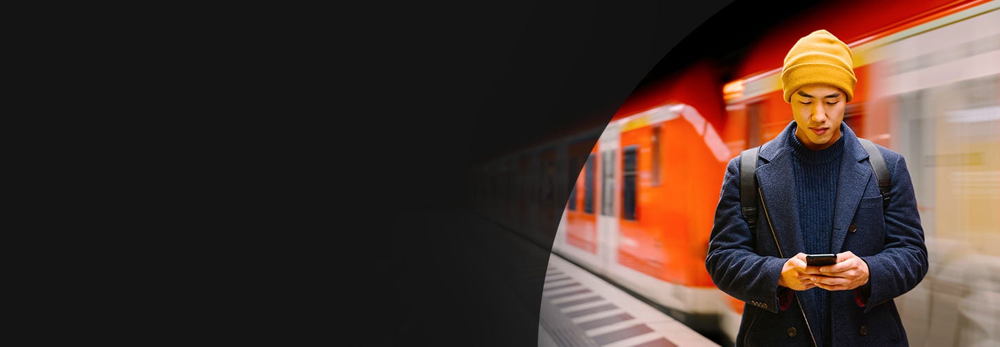 Man texting on phone at the train station
