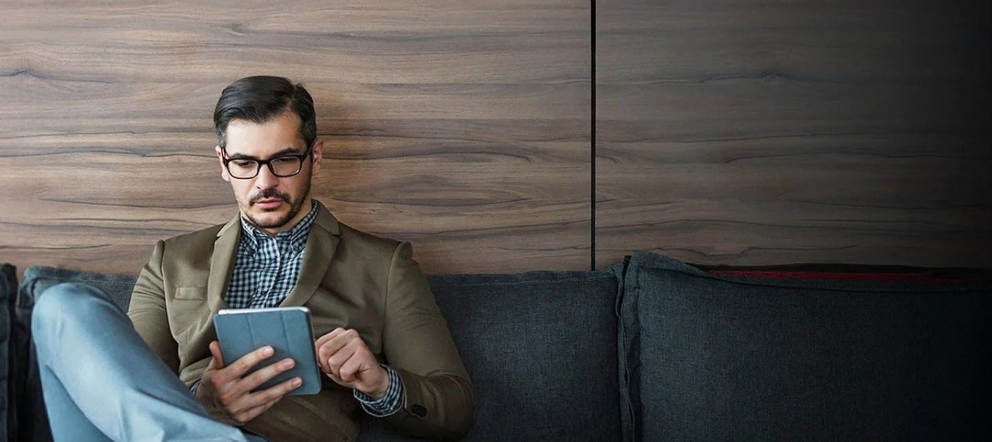 man using tablet on the couch