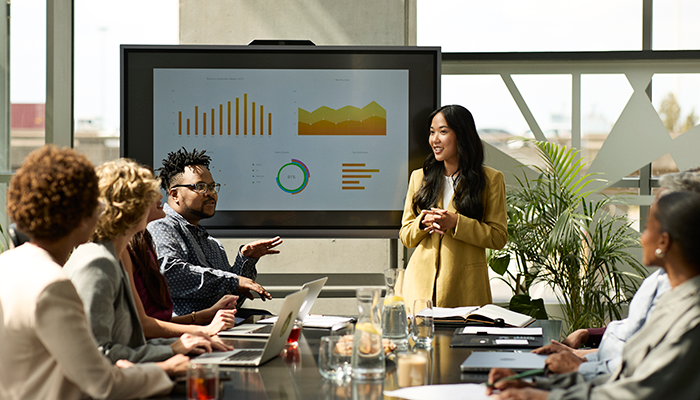 Woman presenting to the larger team