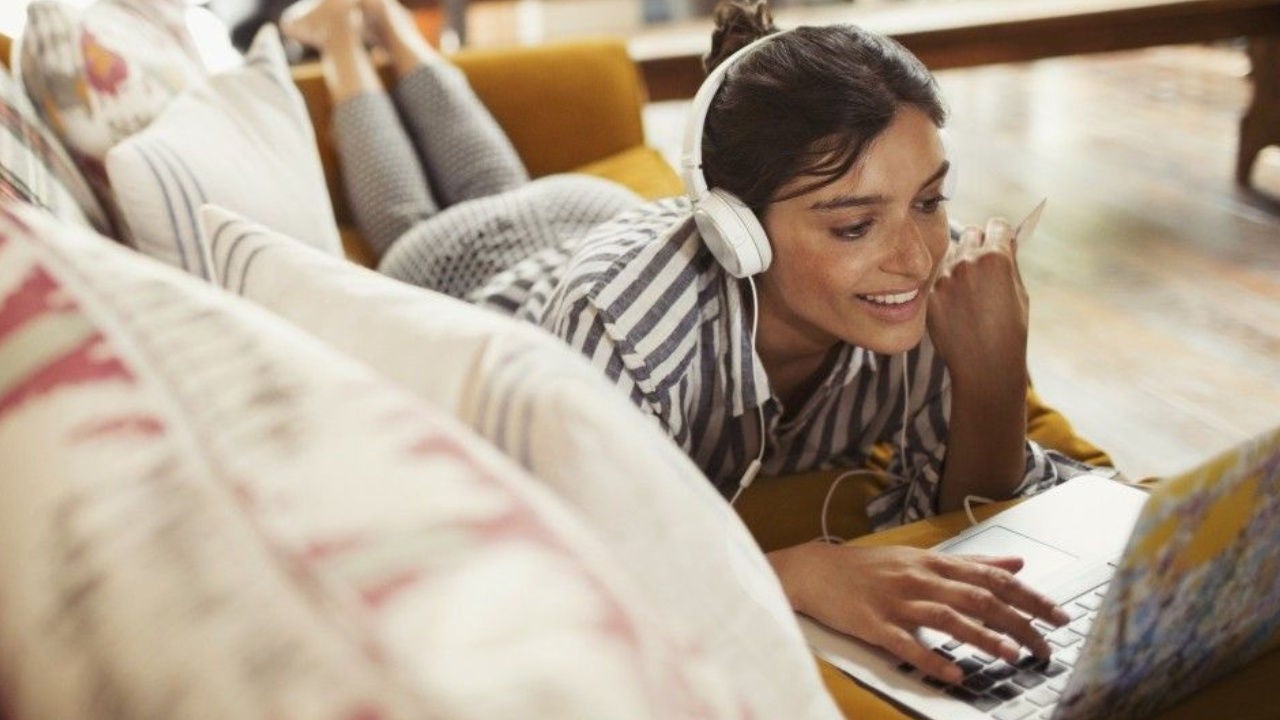 A woman looks at a computer screen with a digital map in the background. 
