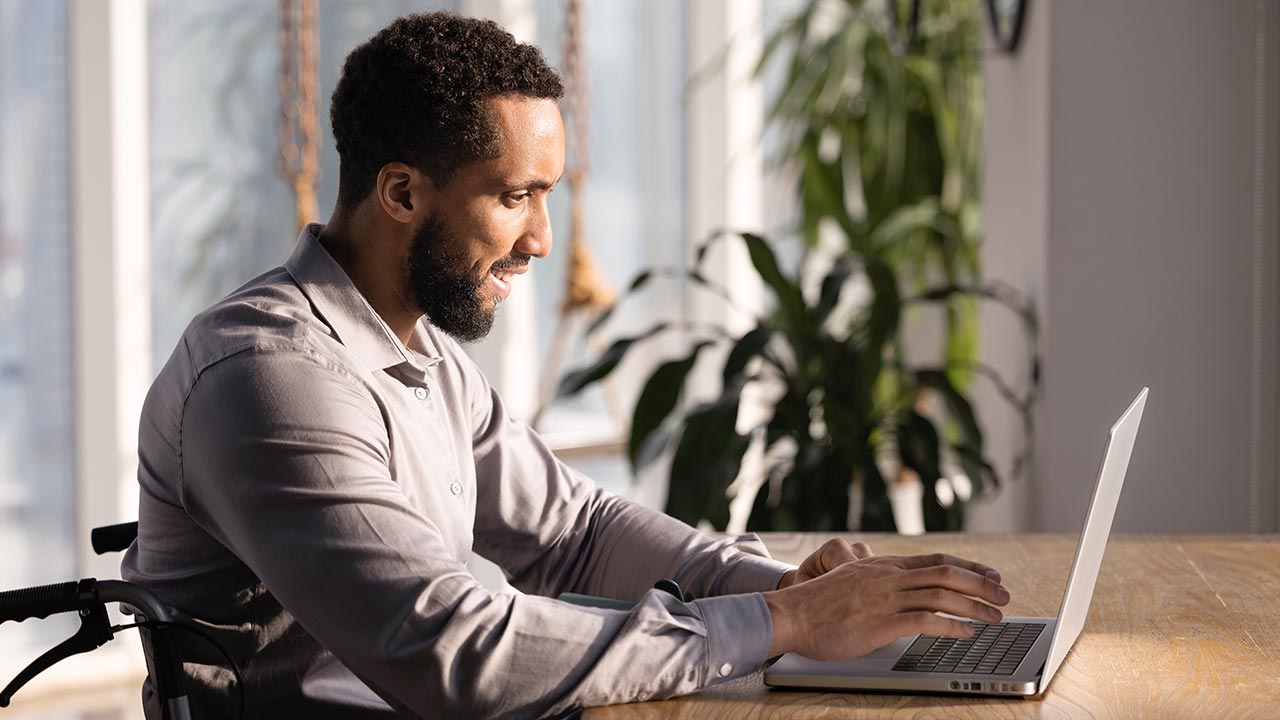 Man on his laptop looking at payment insights