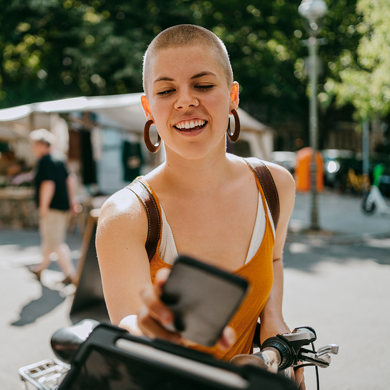 Short-haired woman paying with mobile phone