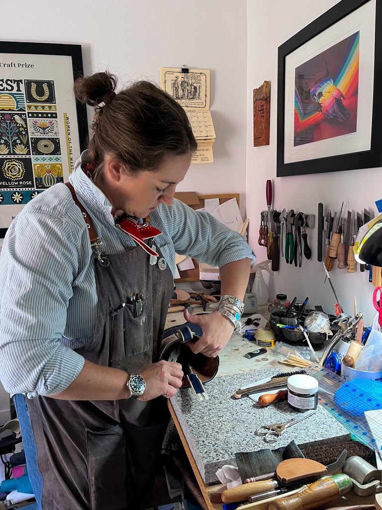 Morgan Buckert wrestles with a boot in her studio. 