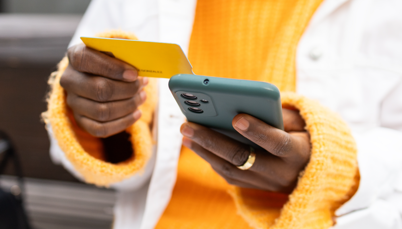 Woman holding her phone and card