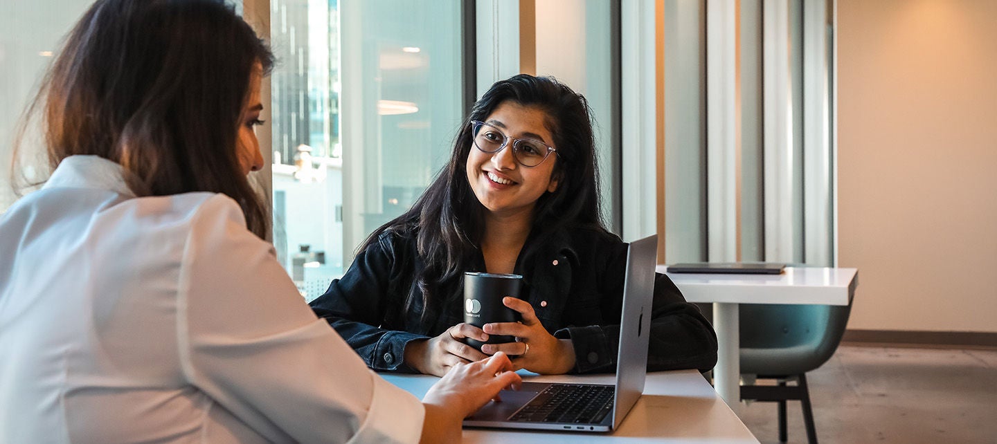 coworkers smiling and talking together.