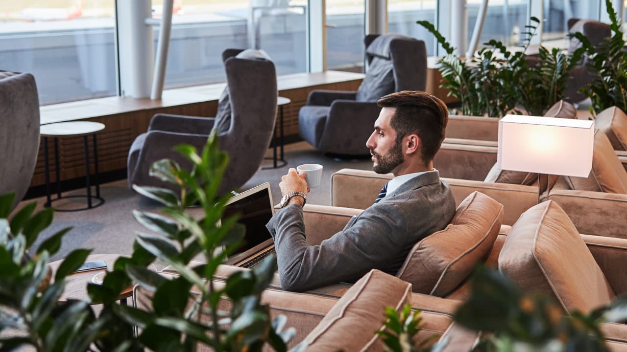 man with laptop in a lounge
