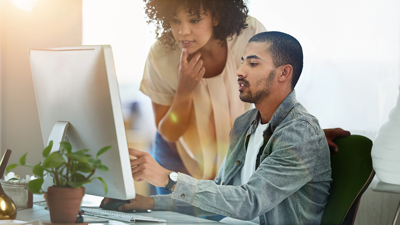 Man and woman looking at computer