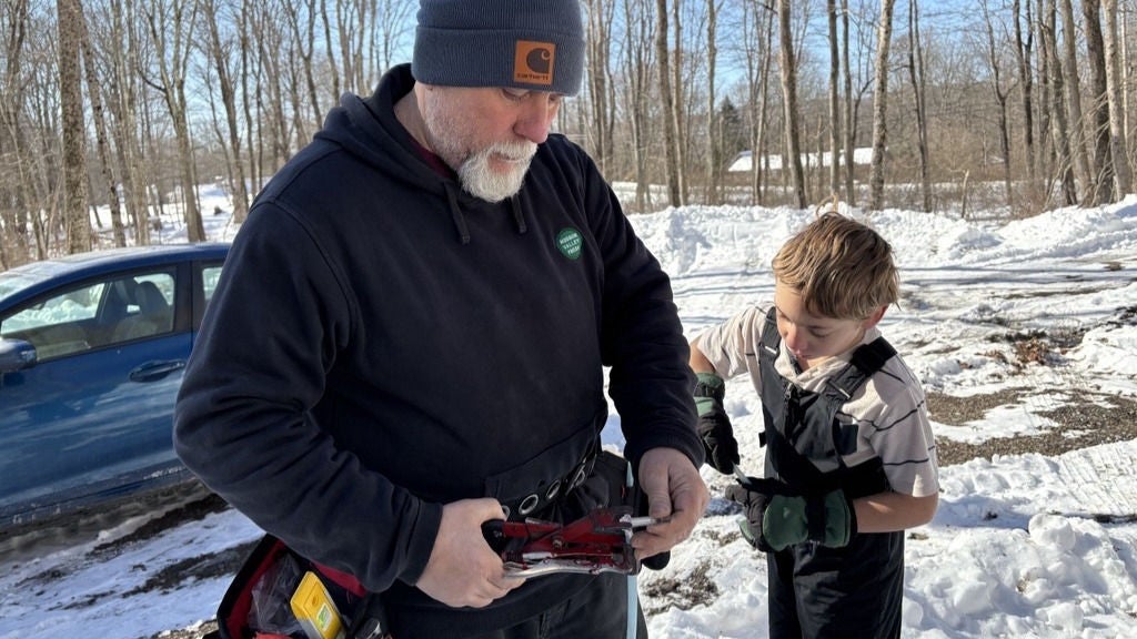 Trevor Ballard assembles a fitting with his son John-Daniel. 