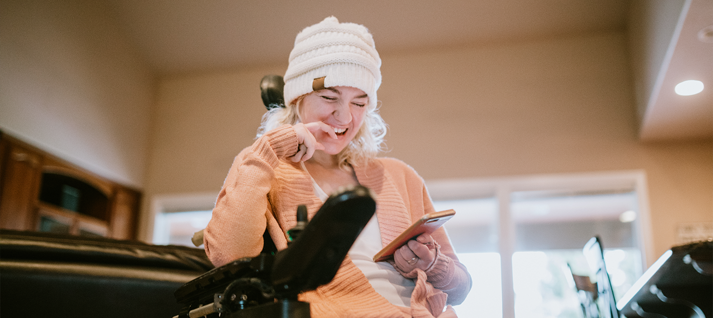 Woman at home searching on her phone